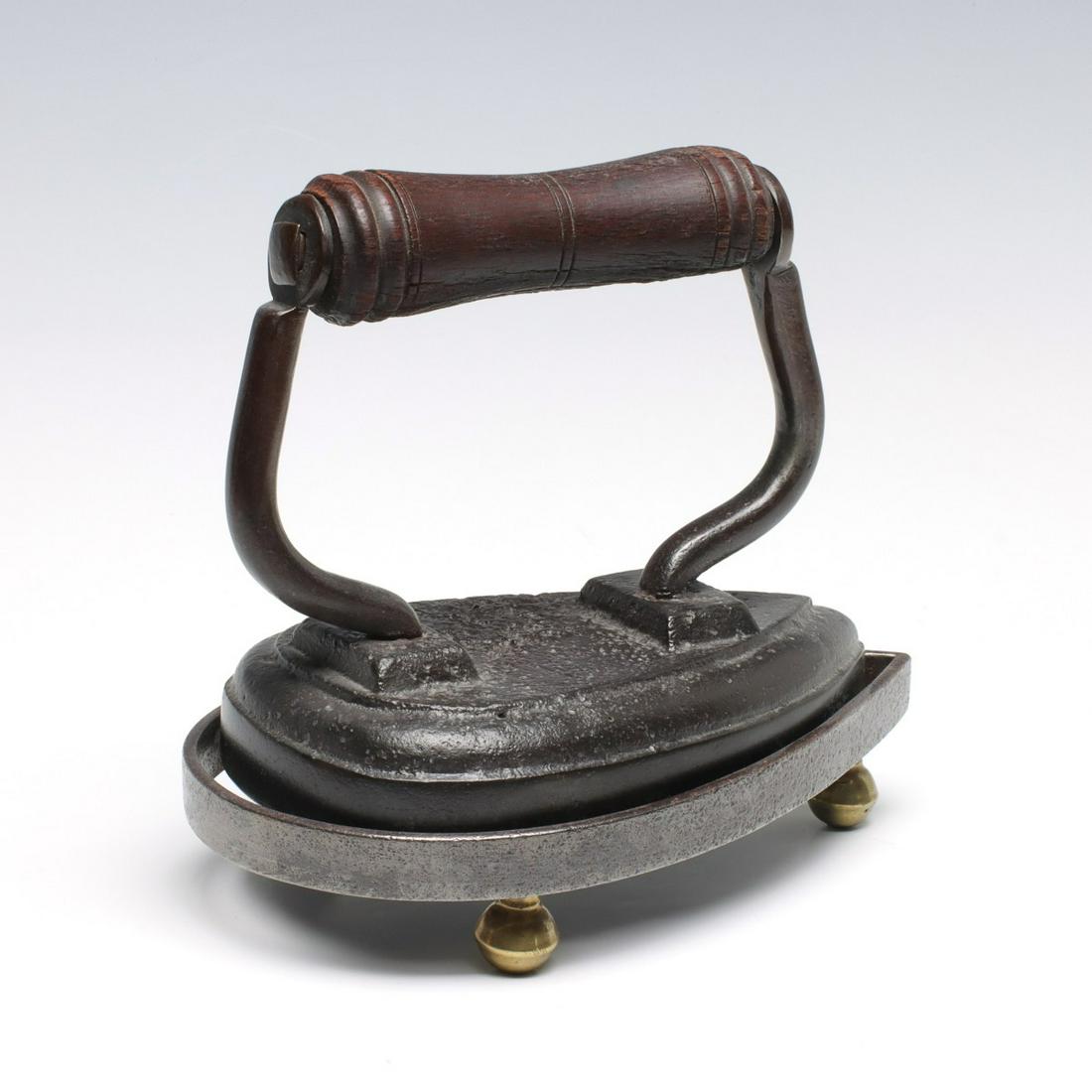 AN UNUSUAL SAD IRON WITH MATCHING TRIVET (1 of 6)