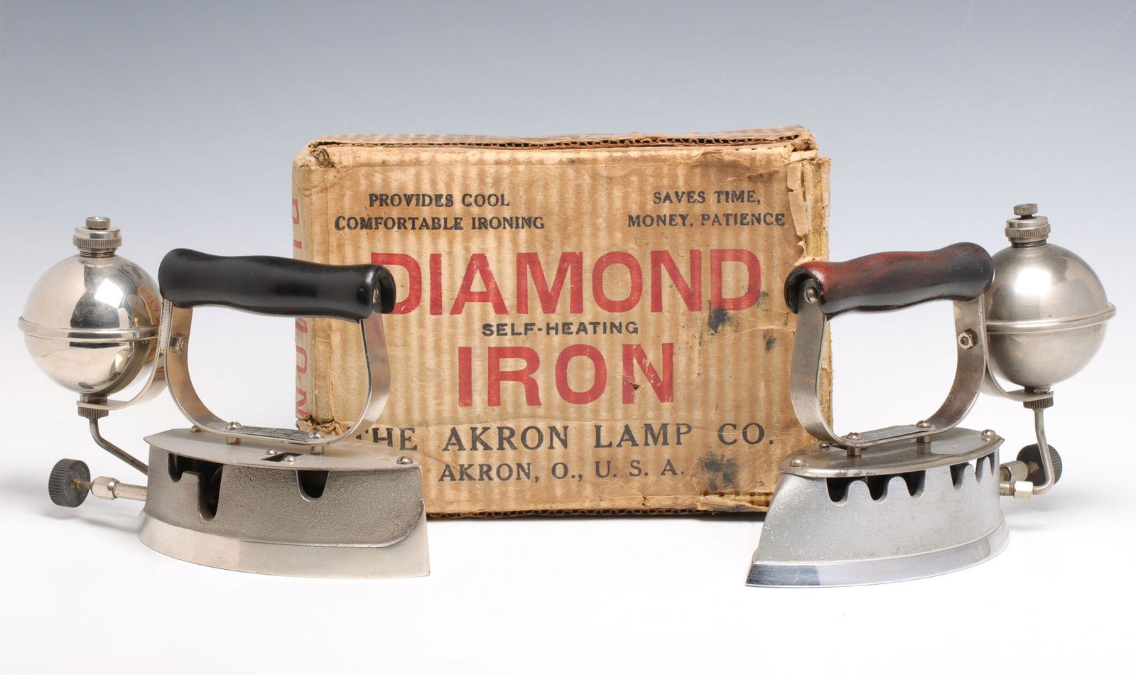 DIAMOND GAS IRONS, ONE WITH BOX: Two Diamond gas irons by the Akron Lamp Company, one with the original branded box and instruction sheet, circa 1930s. Each measures 7 x 9.5 x 3.5 inches. We happily provide seamless in-house packing 