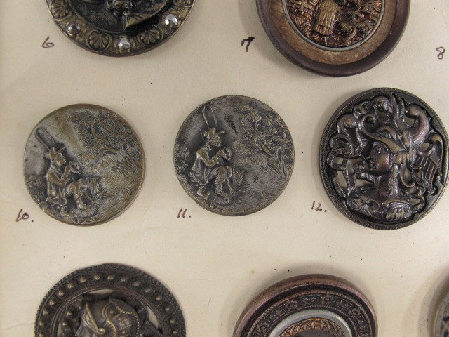 29 ANTIQUE VICTORIAN FIGURAL METAL BUTTONS: Twenty-nine figural metal buttons depicting King Arthur, Falcon Hunter, Jack and Jill, Sir Walter Raleigh, Little Boy Blue, Charlemagne, Marco Polo, a high-relief bulldog's head, and more. Sizes from 