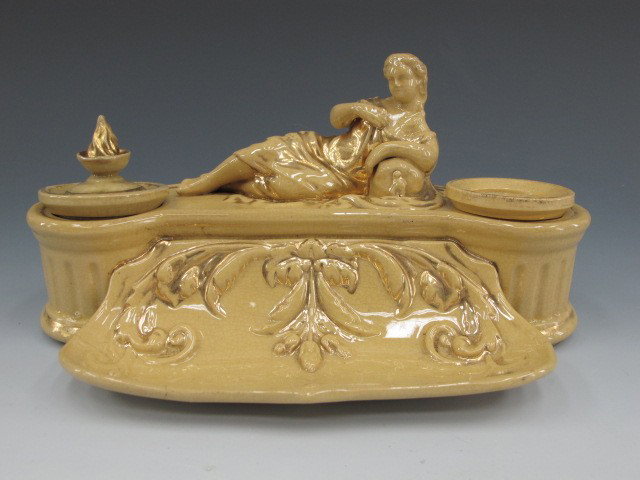 19TH C. YELLOWARE INK STAND WITH SANDER & INKWELL: Yelloware stand surmounted by a reclining lady, gold trim. Inkwell with flame finial, measures 3 x 6 inches.