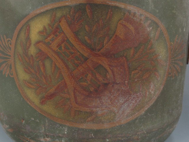 A FRENCH TOLE CACHE POT: Cut and painted tin cache pot with twin applied handles to sides, painted lyre, torch and florals to sides. Measures 6.5 x 6.5 inches.