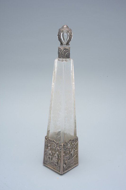 CONTINENTAL SILVER AND CRYSTAL COLOGNE BOTTLE: Hallmarked silver mounts on etched crystal measuring 9 inches tall on a 1.75 inch square base.