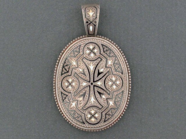 A FINE VICTORIAN SILVER LOCKET: A great hand engraved silver locket with Taille d' epargne enamel technique, glass back removes for hair or photo, unmarked, measurements of 2.25 x 1.25 inches and weight of 16 grams.