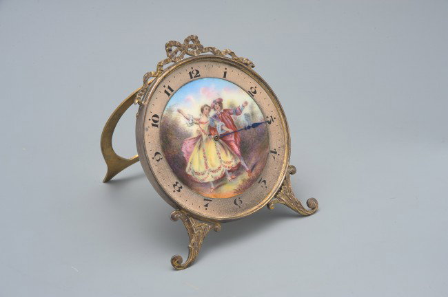 A FINE SWISS ENAMEL AND STERLING CLOCK: An enameled dial with silvered outer numeral ring, painted numerals, marked sterling Germany, Schild & Co. Swiss. Measures 4.325 x 3.5 x 3.5 inches.