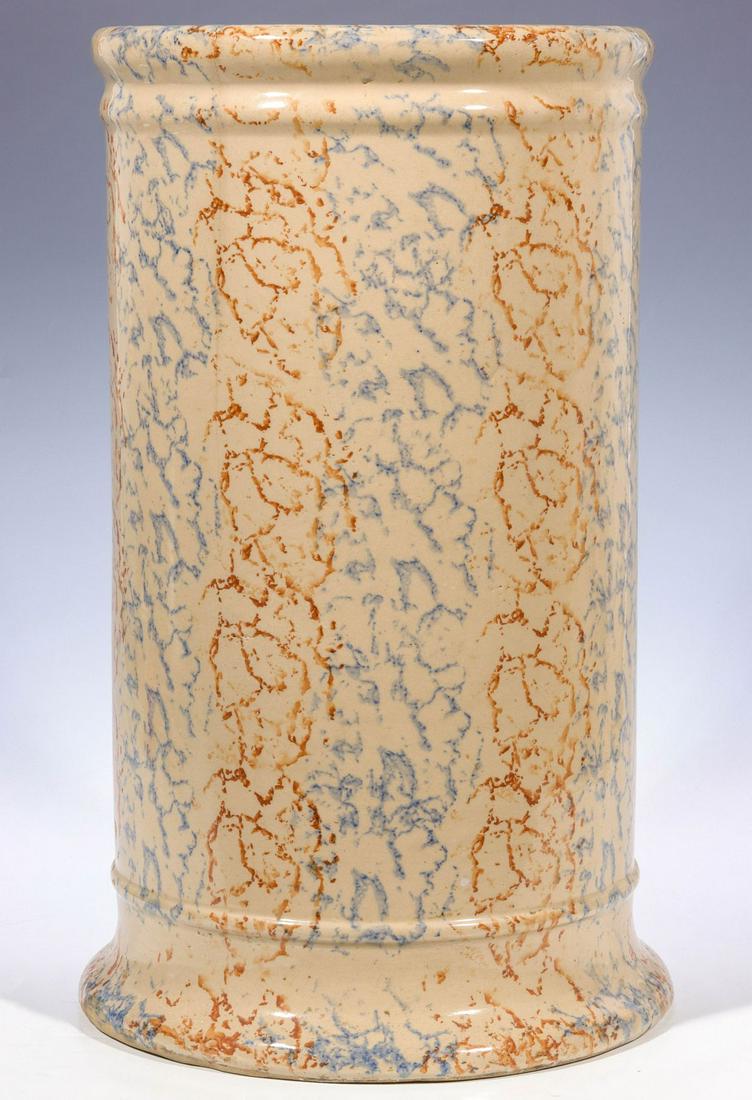 A SPONGEWARE UMBRELLA STAND CROCK: The cylindrical cane and or umbrella holder decorated in blue and rust spongeware technique, unsigned. Measures 17.75 x 11 inches. We happily provide seamless in-house packing and shipping services on