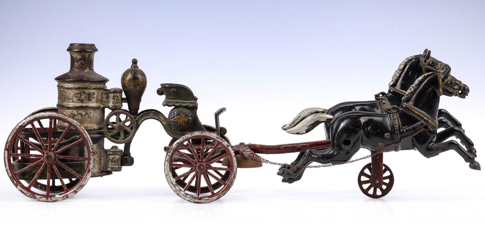A 19TH C AMERICAN TOY CAST IRON HORSE DRAWN FIRE PUMPER: The cast iron horse drawn toy attributed Hubley/ Ives retaining the majority of its original paint as shown here is missing the driver fireman. Measures 6.75 x 19.5 x 3.75 inches. We happily provide s