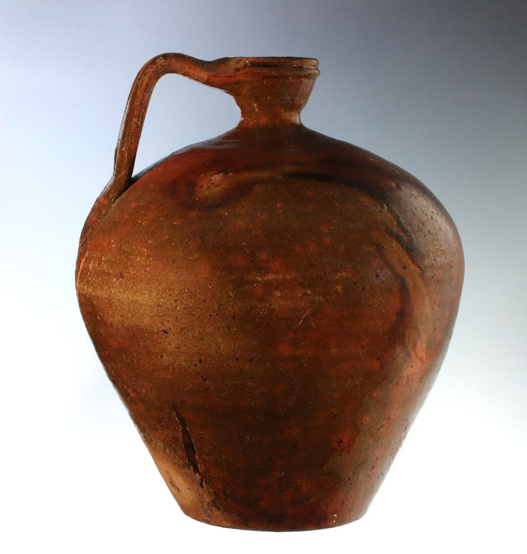 A NICE, LARGE, EARLY, OVOID REDWARE JUG: The ovoid form with pinched neck, dished mouth and strap handle is unsigned, possibly French. Measures 13 x 10 inches. We happily provide seamless in-house packing and shipping services on nearly ever