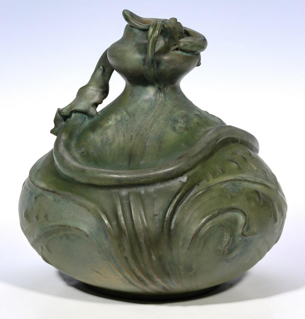 REISSNER, STELLMACHER & KESSEL ART NOUVEAU POTTERY VASE: The Design Attributed To Eduard Stellmacher (1868-1945) 1892-1900 The bulbous organic form with constricted neck encircled by a snake is glazed in matte green with firing highlights, and signed Riessn