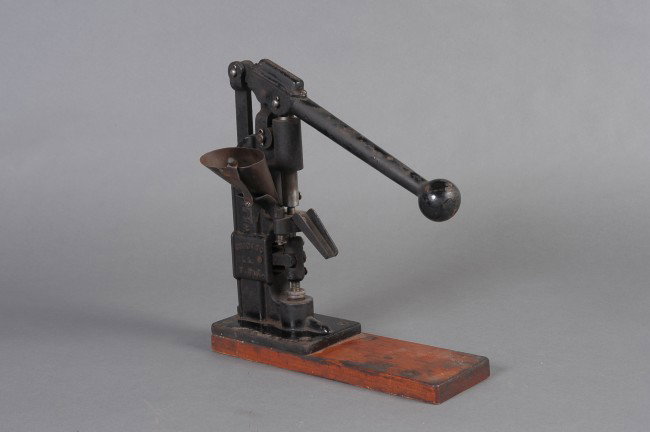 ANTIQUE WILLIAM FRECK PRESCRIPTION PILL PRESS, CIRCA 18: Circa 1890's heavy cast iron pill press / mold, raised lettering 'Wm Freck Co., Chicago Ill, USA.' Powder funnel, hinged press, downward chute. Screwed down to wooden base. Black finished, appears fun