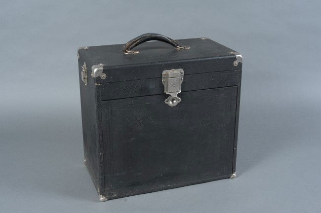 AN H. GERSTNER & SONS TRAVELING DENTIST'S CASE: Hinged lid opening to a set of three hinged pull-up shelves with troughs for instruments. Front hinged panel pulls down to reveal a set of ten drawers, large and small, many still with vintage impleme