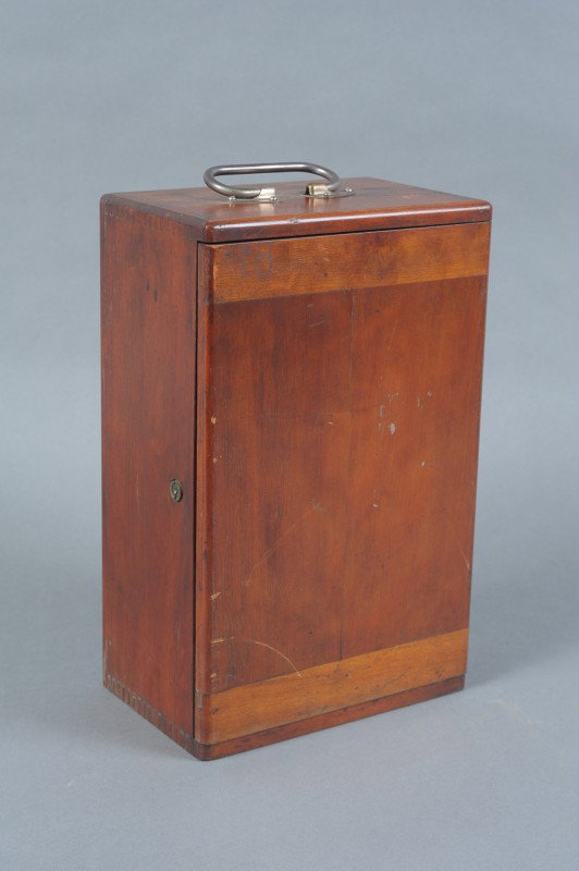 GRUNDLACH-MANHATTAN MICROSCOPE AND CASE: A Grundlach-Manhattan microscope with three objectives. Adjustable angle, swivel mirror. Extra GMO Co 7x eyepiece. Storage drawer inside dovetailed wood case with two empty lens cases, a partial box o