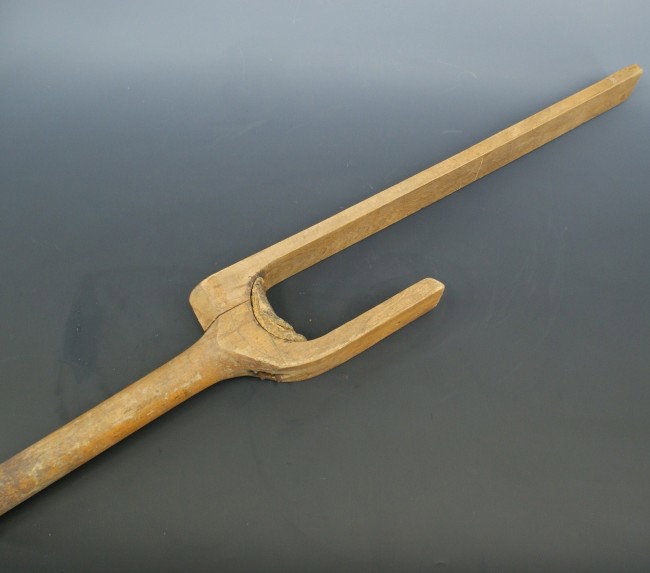 A 19TH CENTURY WOODEN PEG LEG PROSTHETIC: Original two-piece wooden leg with remnant foam padding in the 'U' and leather on the end of the peg. Measures 41 inches tall.