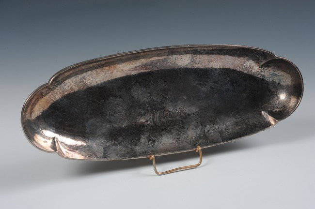 T C CHICAGO ARTS & CRAFTS STERLING SILVER TRAY: An elongated sterling silver tray, hand hammered and with four offset folds. Marked "The T C Shop Chicago Hand Wrought" The work of former Kalo Workshop silversmith Emery Todd. Measures 10" x 3.75" an