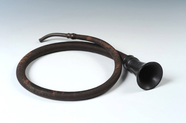 CIRCA 1900 CONVERSATION TUBE EAR TRUMPET: Antique medical artifact. Hardened rubber ear piece and funnel end, flexible black mohair tubing; measures 41.5 inches in length. Tubing in good condition.