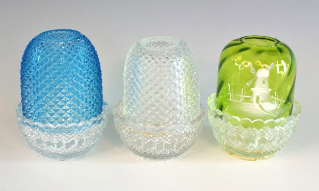 THREE FAIRY LAMPS, ONE MARY GREGORY: Includes 'S. Clarke' marked clear bases, one smooth green swirl glass with Mary Gregory windmill painted scene, stands 3.75 inches. Also one with blue shade, stands 4 inches; clear 3.75 inches.