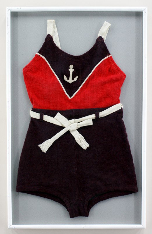 LADIES VINTAGE WOOL SWIMSUIT: A purple and red ladies swimswimswimsuit with cream shoulder straps and belt. Has cream piping in a V-shape around a cream anchor patch on the chest. Suit measures 27 x 17 inches in a 30 x 19 inch fra