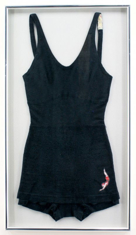 LADIES JANTZEN VINTAGE WOOL SWIMSUIT: Jantzen swimswimsuit in black with the Jantzen logo patch on the lower left leg. Visible label says 'John Taylor Dry Goods Co. Kansas City' and 'Misses 18.' Nicely blocked and framed in a brushed silv