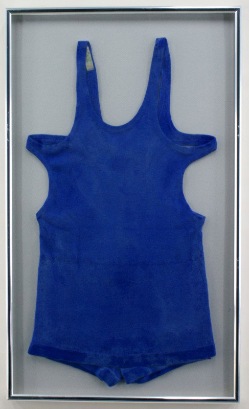 TWO LADIES VINTAGE WOOL DIVER STYLE SWIMSUITS: One royal blue diver swimsuit measuring 28 x 15.5 inches in a 33 x 19.5 inch frame. Visible label says 'Munsing Wear 100% Wool.' One navy blue diver swimsuit measuring 29 x 15.5 inches in a 33 x 19 in