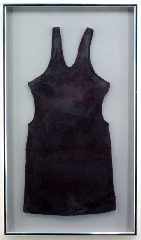 TWO CHILDREN'S VINTAGE WOOL SWIMSUITS: One child's dark brown swimsuit measuring 25 x 12.5 inches in a 31 x 18 inch frame. One dark red child's suit measuring 26 x 12.5 inches in a 31.5 x 16 inch frame. Both are nicely blocked and framed i