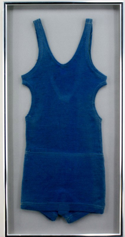 TWO CHILDREN'S VINTAGE WOOL SWIMSUITS: One child's teal diver swimsuit measuring 27 x 11.5 inches in a 31.5 x 16 inch frame. One child's red diver swimsuit measuring 27 x 12 inches in a 31.5 x 16 inch frame. Both are nicely blocked and fra