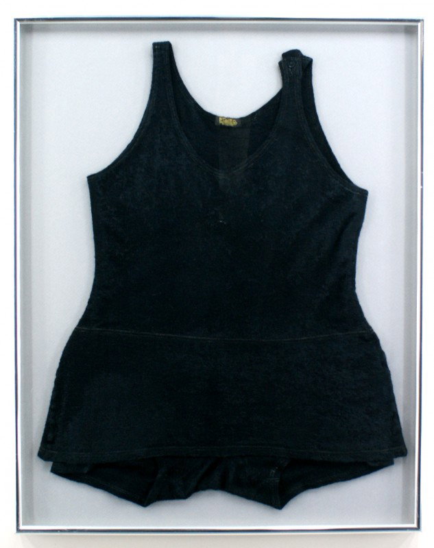 TWO VINTAGE WOOL SWIMSUITS: One large black wool swimsuit with a one-button shoulder closure. Visible label says 'Elbro guaranteed Knitwear Milwaukee.' Swimsuit measures 30 x 24 inches in a 34 x 27 inch frame. One burgundy red p
