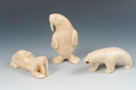THREE CONTEMPORARY ESKIMO CARVED IVORY FIGURES: Includes a standing walrus, 4.5 inches; a walrus and pup, 1.75 x 4 inches; and a polar bear, 2 x 4 inches. PLEASE NOTE: No shipping outside the USA for any ivory.