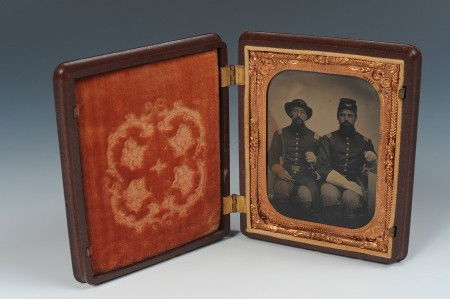 TIN TYPE IMAGE OF CIVIL WAR OFFICERS: Union Army Captain on the left wearing a slouch hat with horn insignia and numbers which appear to be either 54 or 51; other in a kepi, insignia present but not legible. Both men seated, wearing gaunt