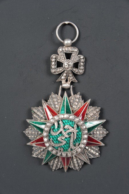 TUNISIAN ORDER OF NICHAN IFTIKHAR: Die struck multi-piece with translucent red and green rays, applied center roundel. Reverse with 'Arthus Bertrand, Paris' maker mark. 50mm diameter, illegible ring marks.
