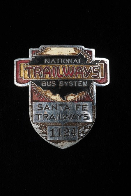 NATIONAL TRAILWAYS SANTA FE BUS CAP BADGE: National Trailways Bus System, Santa Fe Trailways, die struck and enamel painted, double screwback with nuts, measures 2.5 x 2.25 inches.