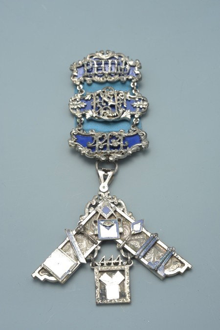 PHILADELPHIA MASONIC GRAND LODGE 444 BADGE: Die struck multi-piece badge, silver toned pinback brooch with blue center and applied 'Philo' suspending cypher over blue center, suspeding yet another bar with blue center surmounted by a '444,' sus