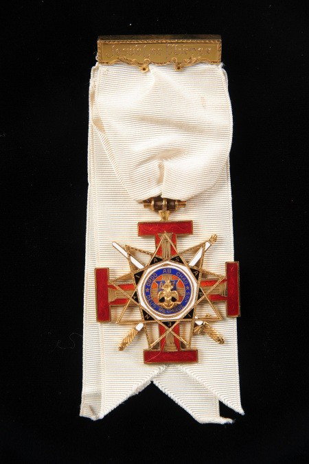 SCOTTISH RITE KANSAS CITY TEMPLE ENAMEL BADGE: Scottish Rite badge in gilt and enamel, tested 14K gold, engraved 'Presented to brother Jesse Lee Porter by Adoniram Lodge of Perfection #2, Kansas City, Missouri, October 25, 1921.' On white ribbon a