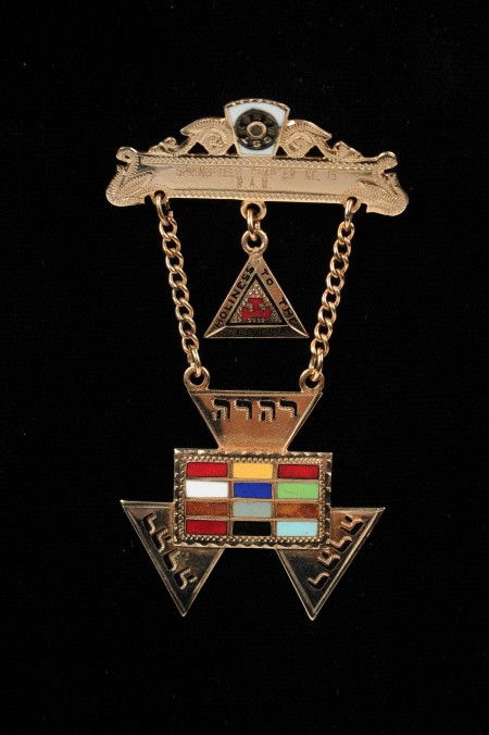 10K GOLD ROYAL ARCH MASONS MEMBER BADGE: Pinback brooch with enamel, engraved 'Springfield Chapter No. 15 RAM,' reverse marked '10KT' and 'George A. Sweeton, 1966.' Chain suspended emblem with enamel application. 2.25 x 1.25 inches, weighs 5