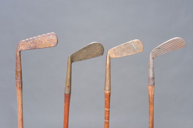 FOUR ANTIQUE WOOD SHAFT GOLF CLUBS: Includes Cedar Brook special putter, a J. Patterson putter with serrated bottom, an unmarked scored line club, and a McGill Metal Klin Klub mid-iron.