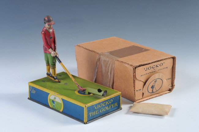 A JOCKO THE GOLFER TIN LITHO TOY WITH BOX: An original tin litho 'Jocko the Golfer' mechanical toy, pull cord winder works fine, even includes an unopened small envelope of little red golf balls. Measures 6.5 x 6.5 x 4 inches. Also includes or