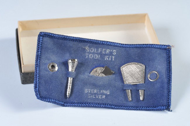 A STERLING SILVER GOLF TOOL SOUVENIR SET: Includes .59 Troy ounces of sterling marked silver, formed as a tee, spanner and putting marker. With a fading blue velveteen holder and cardstock box.
