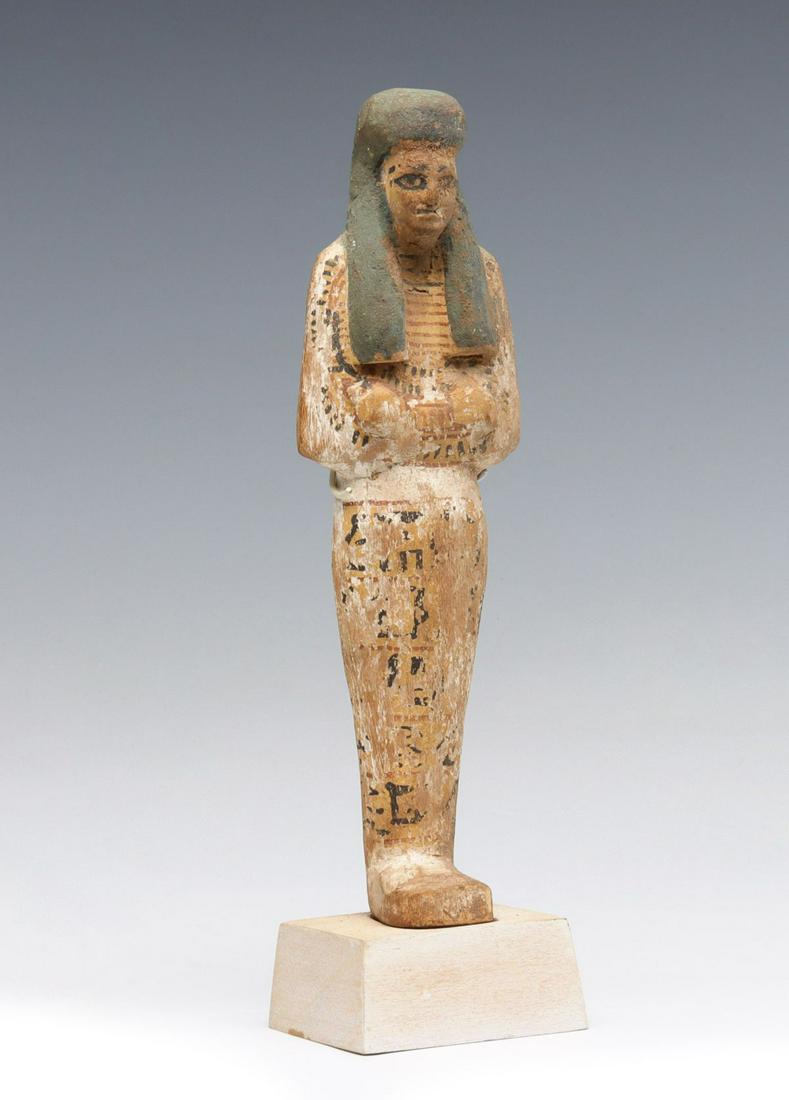 AN EGYPTIAN NEW KINGDOM PAINTED WOOD USHABTI (1 of 13)