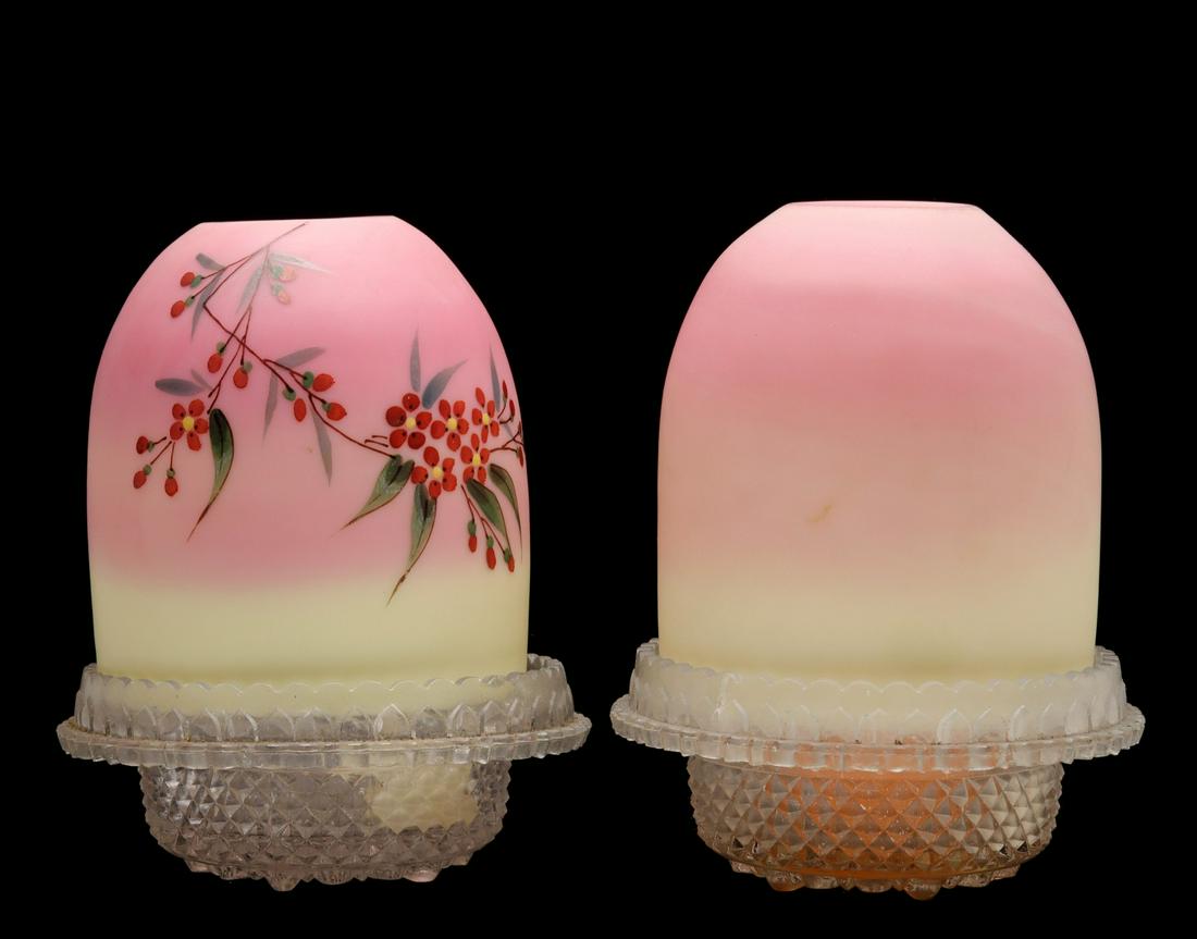 DECORATED AND UNDECORATED 19C. BURMESE FAIRY LAMPS: The Burmese glass shade on one example with its hand painted Forget-me-not blossoms and vines in the manner of Thomas Webb is paired with a very similar example without fired on hand painted enamels .