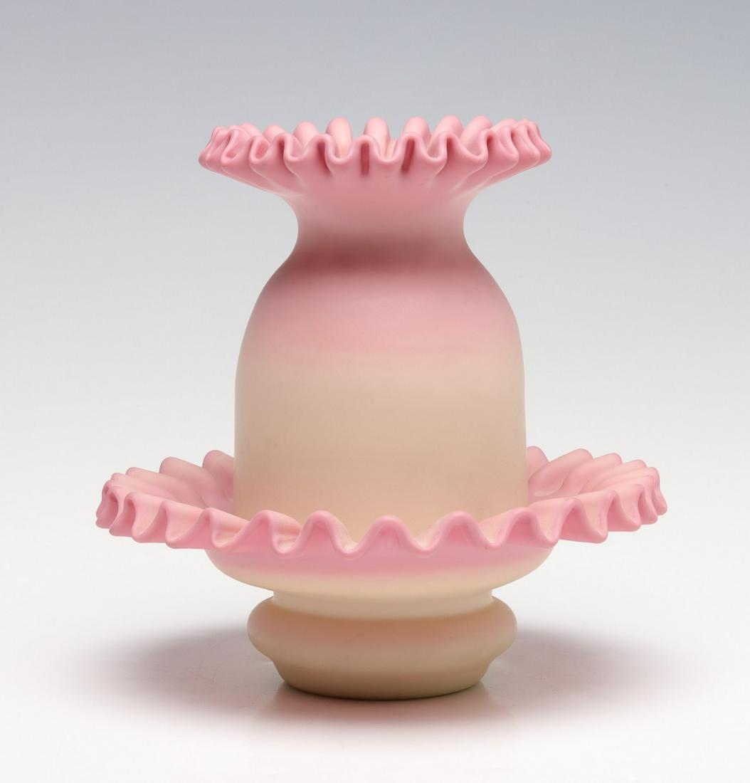 AN UNUSUAL RIBBON EDGE BURMESE FAIRY LAMP: The two-piece fairly lamp with crimped and gathered edges on a blown base with pontil is of the type associated with Thomas Webb. Measures 5.75 x 6 inches. We happily provide seamless in-house packing