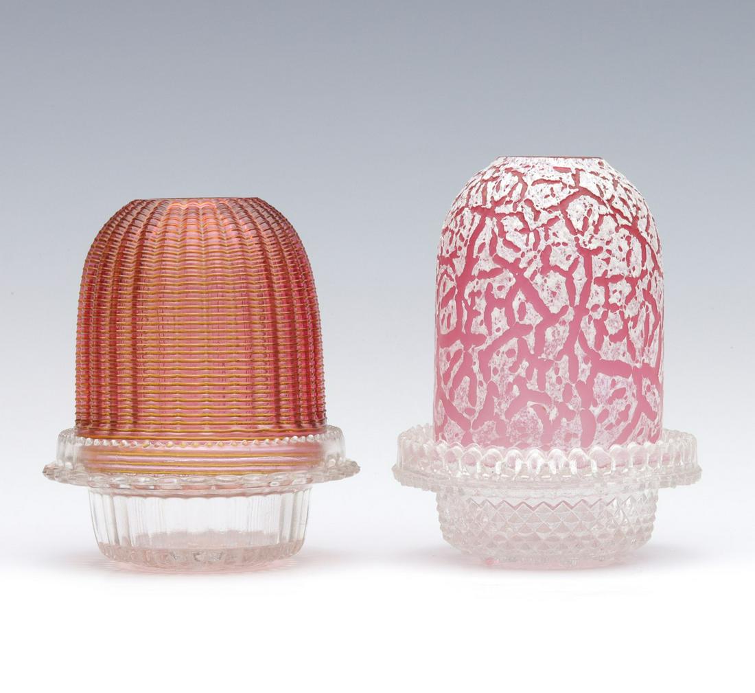 TWO UNUSUAL VICTORIAN ART GLASS FAIRY LAMPS: The examples include a cranberry shade with high ribs wrapped in amber threading on Clarke's base along with a cranberry glass shade having white molten magma enamel exterior. Measures 5 x 4 and 5.5 x