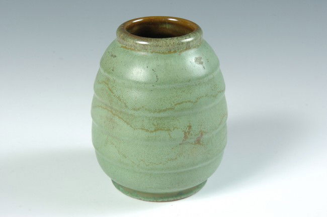A FRANKOMA POTTERY VASE WITH PACING LEOPARD MARK: Prairie Green glaze on body with concentric rings, impressed pacing leopard mark, measures 4 x 3.25 inches.