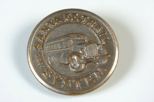 FIVE SANTA FE TRAIL BUS SYSTEM BUTTONS: Five circa 1920's uniform buttons, 7/8 inch diameter, reverse marked 'Superior Quality,' silver finished brass. Also a cuff button.