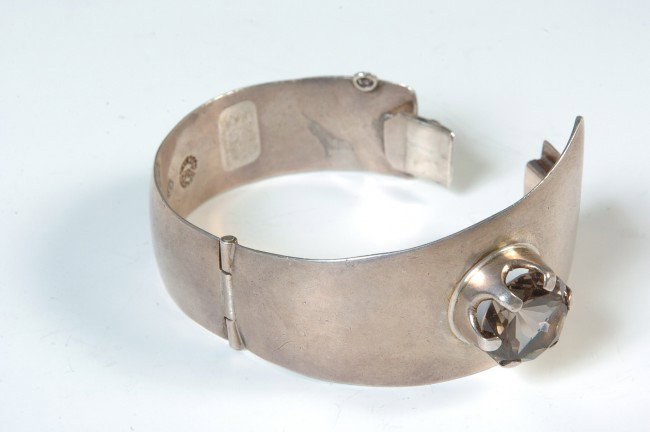 A TAXCO STERLING BRACELET BY ERE: Hinged bracelet with 'Taxco, Mexico 925, ERE' mark and obscure eagle mark. Inset large clear stone. Weighs approximately 2.5 oz.