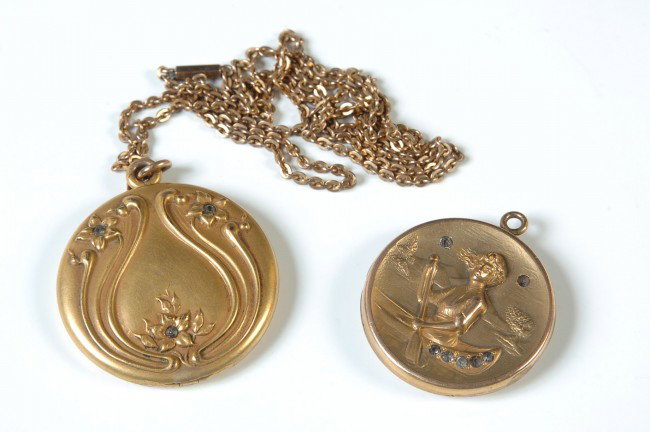 TWO GOOD VICTORIAN LOCKETS: Includes a 1.5 inch diameter locket with three inset stones on front and raised design, with chain. Includes two photos of a little girl and a doll inside. Also a 1-1/8 inch diameter locket containing