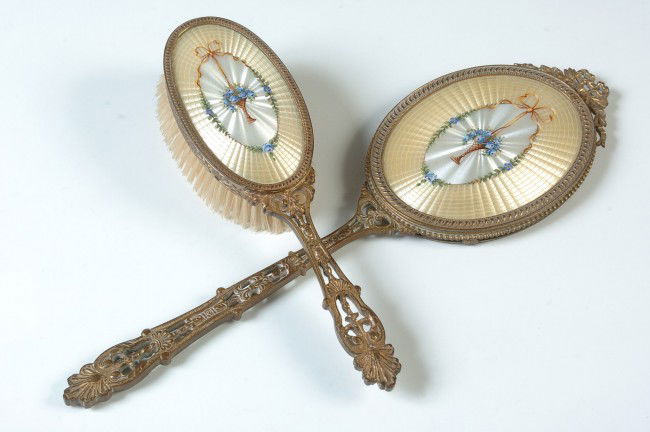 A TWO PIECE GUILLOCHE ENAMEL DRESSER SET: Fine quality guilloche hand mirror and horsehair brush. Ornate handles with gilt finish. Mirror measures 14 x 4 inches, brush 9.25 x 2.5 inches.