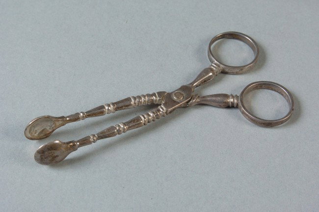 A PAIR OF LONDONG STERLING SILVER SUGAR NIPS: Wakely & Wheeler and London hallmarked along with 'England 327.' 4.25 inches long, weigh approximately 27 grams.