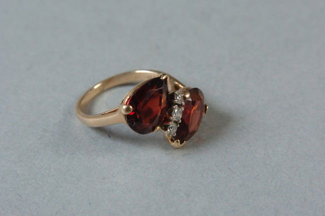 A 14K GOLD TIFFANY & CO MARKED LADIES RING: Size 4-1/2, 14K and Tiffany marked inside band, with inlaid stones, including three small stones that tested positive for diamonds, weighs approximately 4 grams.