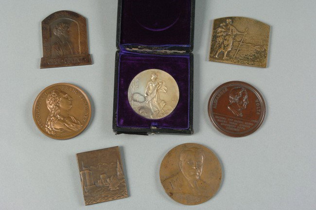 A GROUP OF SIX CIRCA 1900 TABLE MEDALS: Includes a 'Melvin Jones, Founder of Lions Internation' 3 inch medal; Charentaise Marans, 2.5 x 2 inches; Grace Coolidge, 3 x 2.75 inches; 'Amoresccio Via Secur' Rene Baudichon, 2.5 x 3 inches; Alexan