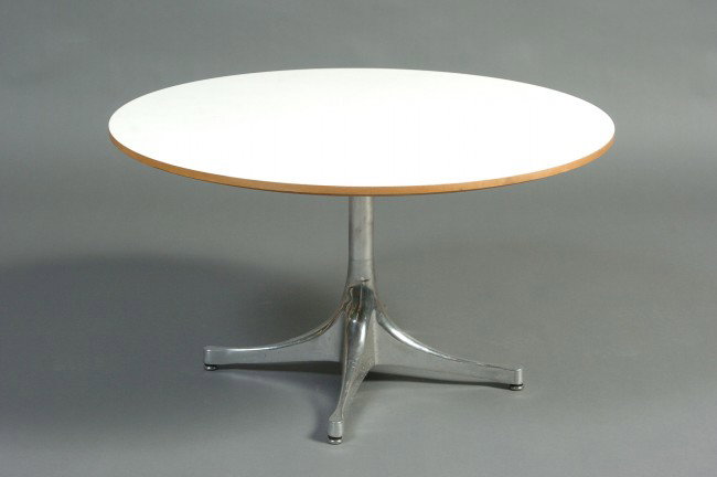 A GEORGE NELSON FOR HERMAN MILLER COFFEE TABLE: With laminate top, maple veneer edge and brushed aluminum base, circa 1954. Stands 16 inches high, 28.5 inch diameter top.
