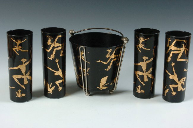 A MID-CENTURY AMERICAN ICE BUCKET AND TUMBLER SET: Includes bucket and four tumblers. Black glass with figures of tribal dancers, bucket measures 5.75 x 6 inches; tumblers stand 7 inches each.
