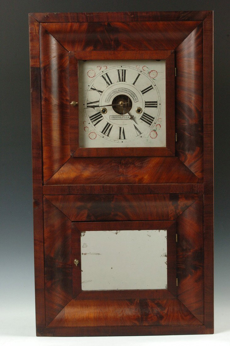 A FORESTVILLE TWO DOOR OGEE SHELF CLOCK 1849-1853: Two recessed doors, highly figured mahogany, original dial with mispelled Forrestvill, original mirror tablet, paper label inside, . 30.25 x 17.25 x 4.5 inches overall. Veneer replacement